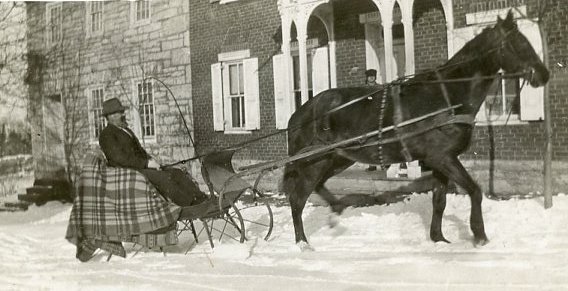 Man driving a horse drawn sleigh
