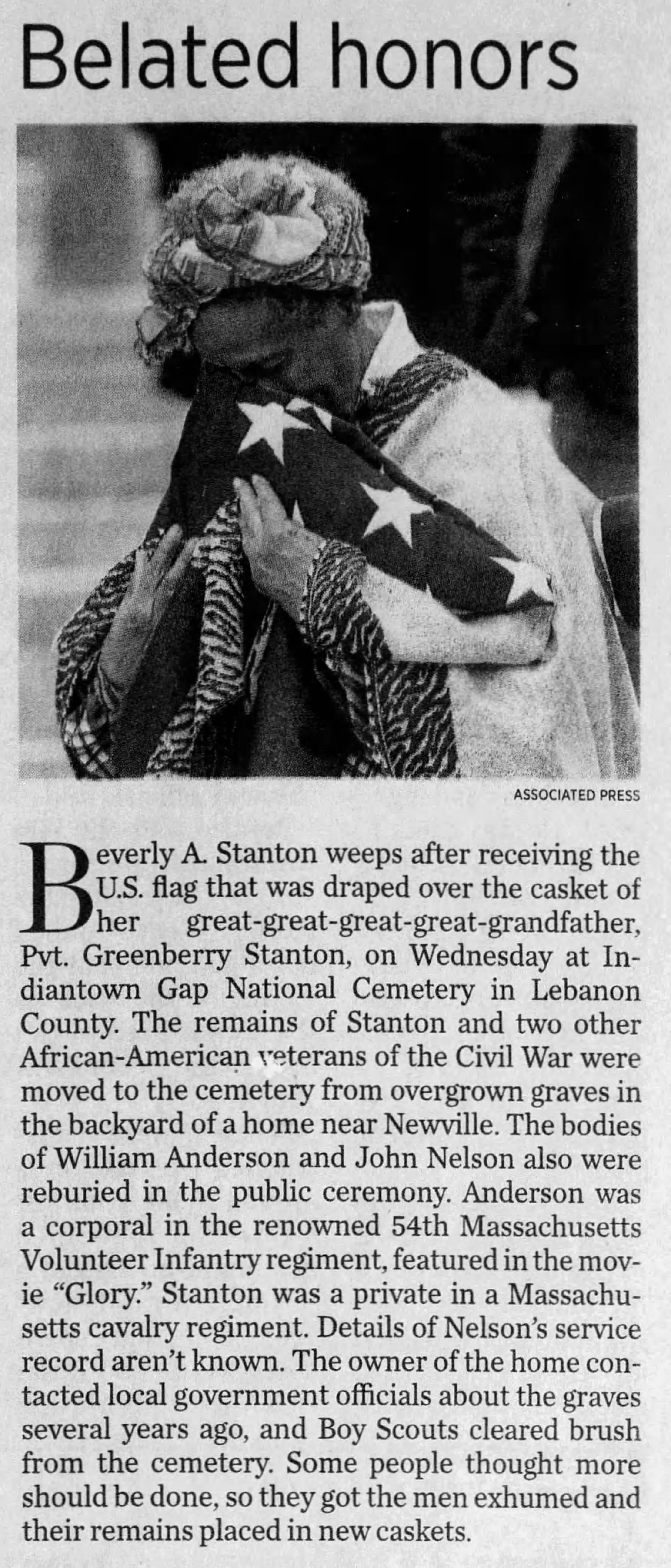 Headline reading "belated honors". Image shows a woman crying into a triangle-folded American flag. Article tells story of Greenberry Stanton's grave being exhumed and reburied with full military honors. 