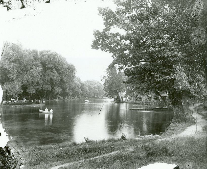 The lake at Boiling Springs; both sides of the lake can be seen and there are two canoes in the water. 