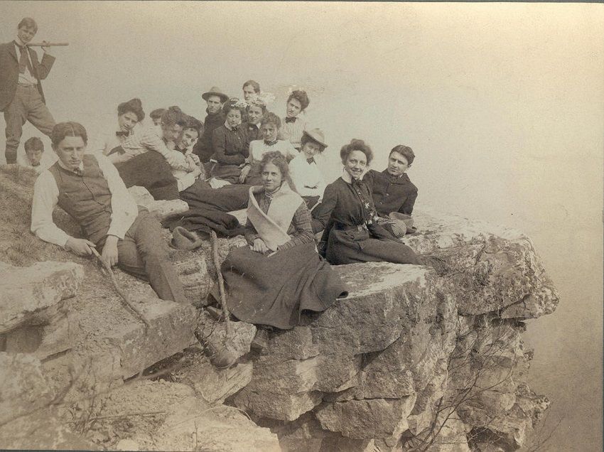 Photo of approximately seventeen young people sitting on rocks at Flat Rock, Doubling Gap, Pennsylvania.