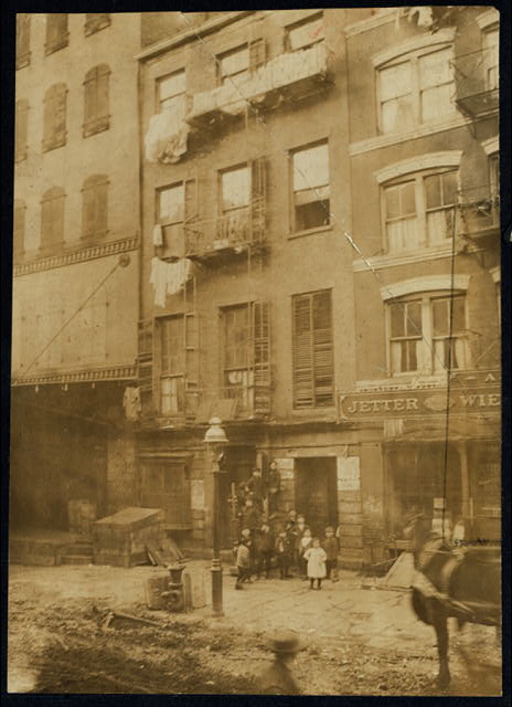 Tenement house with children in front