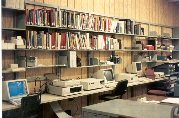 Photo of bookshelves and computer terminals in Hamilton Library.