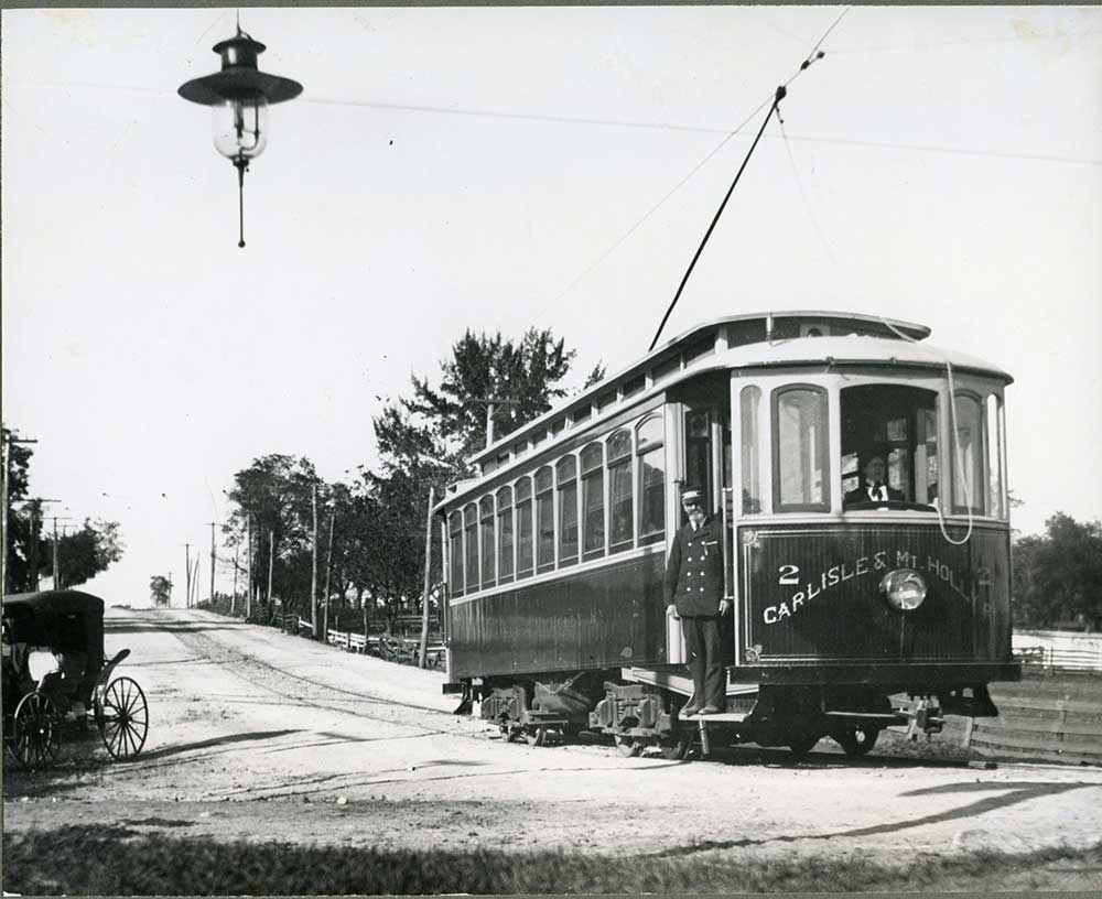 Photo of the Carlisle and Mt. Holly trolley standing near Hanover and Ridge streets. Note the old street lamp.