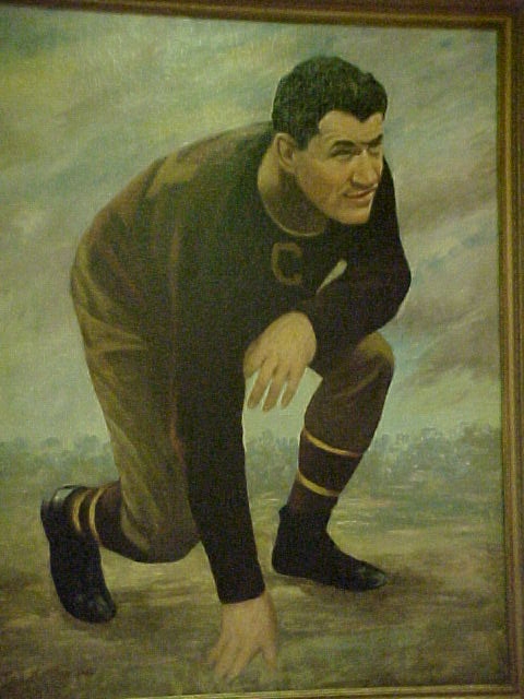 Photo of a framed oil portrait of Jim Thorpe in football uniform by Paul Bloser in 1959.