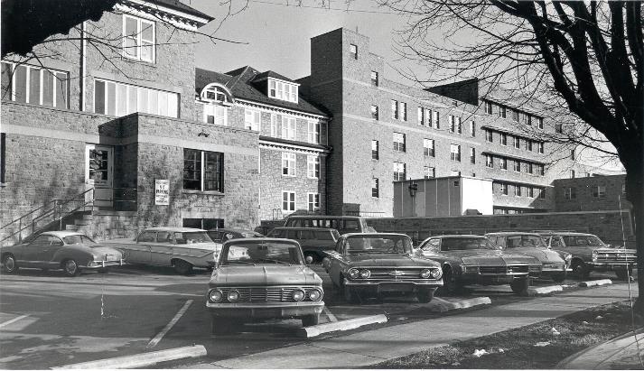 Photo of the Carlisle Hospital; rear view showing parking lot with automobiles