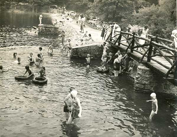 Photo of families swimming in a lake at Colonel Denning Park, in 1956