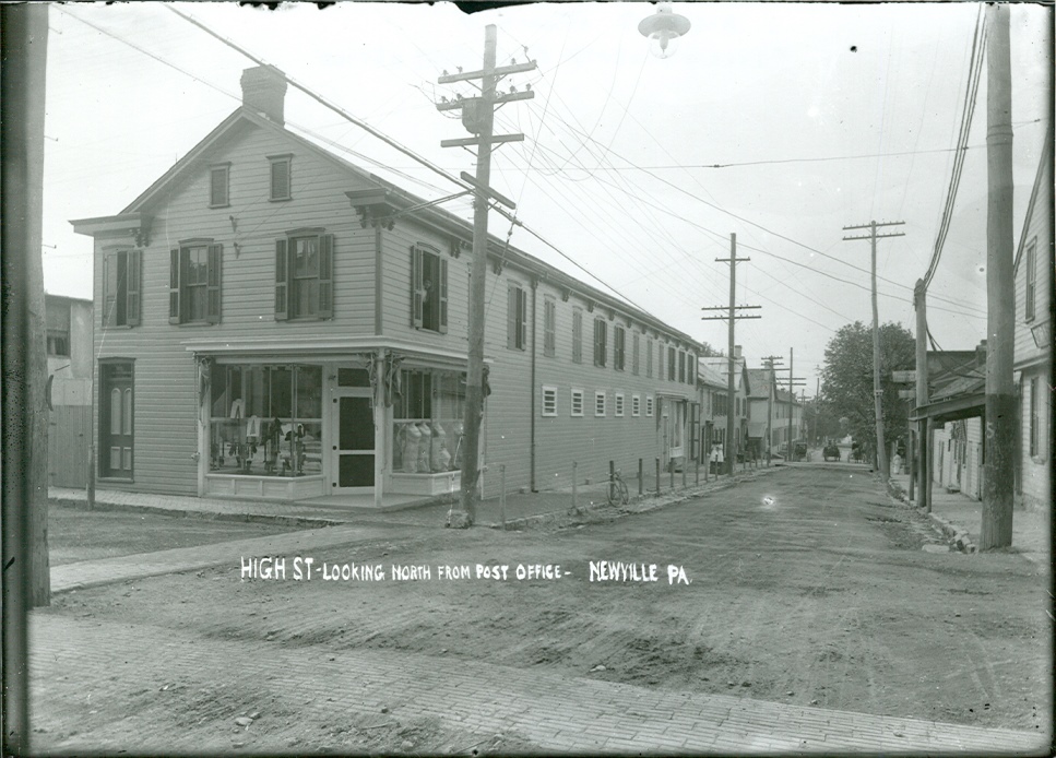 Photo by Maynard J. Hoover of A view of businesses and buildings on High Street in Newville, PA, circa 1910.