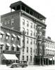 Photo of an exterior view of the Molly Pitcher Hotel and the A&P Grocery store, with a 1920s automobile parked on the street.